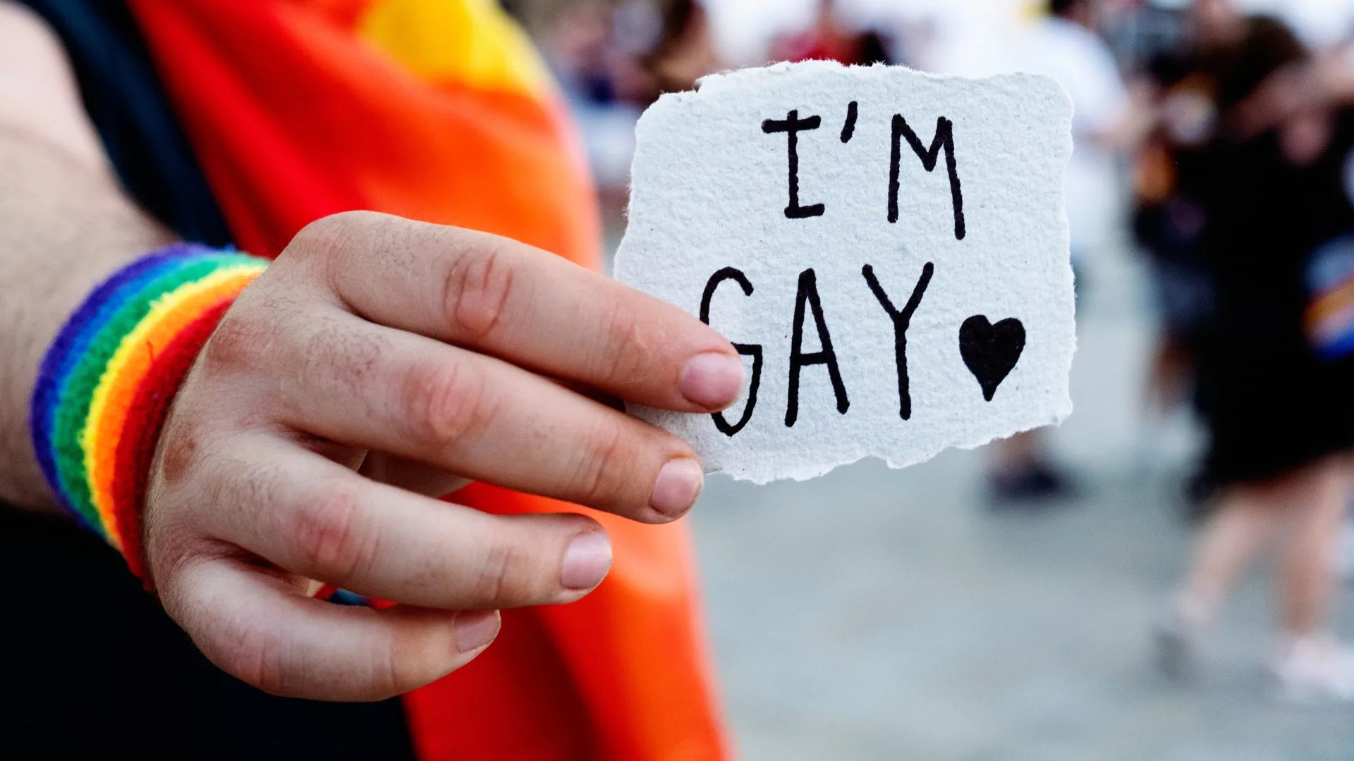 Man Showing a Note with the Text I Am Gay